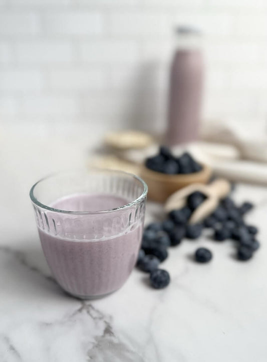 Glass of homemade blueberry milk